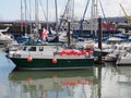Small commercial fishing boat in scarborough harbour surrounded by yachts and trawlers Royalty Free Stock Photo