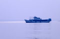 A Small Commercial Fishing trawler nautical vessel on river inland water before heading out to Bay of Bengal. Late evening view