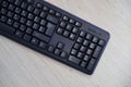 Small compact black gaming computer keyboard on a table made of wooden pine boards. Wireless keyboard with mechanical Royalty Free Stock Photo