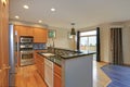 Small compact kitchen room with light wood cabinetry Royalty Free Stock Photo