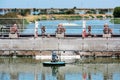 Small concrete dam separates the wastewater treatment facility oxydation ponds