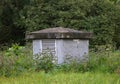 Small concrete vent outlet in the green grass