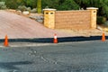 Small cones outside of construction area in front yard three orange and white plastic with small retaining wall drive way Royalty Free Stock Photo