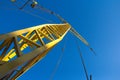 A small construction crane on a background of blue sky. Industrial background Royalty Free Stock Photo