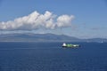 Small container ship sailing near sea coast close to Gibraltar. Royalty Free Stock Photo