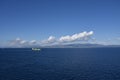 Small container ship sailing near sea coast close to Gibraltar. Royalty Free Stock Photo