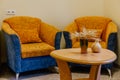 Small corner of a hotel room with two armchairs and an oval wooden table Royalty Free Stock Photo