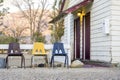 Small cottage house with 3 chairs in front of it. Royalty Free Stock Photo