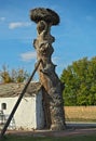 Small cottage beside old tree with stork nest Royalty Free Stock Photo