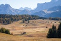 Small cottage in vast and beautiful autumn landscape with mountains and woods, Dolomites, Italy Royalty Free Stock Photo