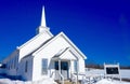 Small country New England church in snowy field Royalty Free Stock Photo