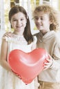 Small couple holding red heart Royalty Free Stock Photo