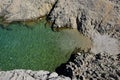 Small cove surrounded by rocks, crystal clear water and heart made of stones at the entrance to water. Location Vrsi, Croatia, Adr Royalty Free Stock Photo