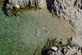 Small cove surrounded by rocks, crystal clear water and heart made of stones at the entrance to water. Location Vrsi, Croatia, Adr Royalty Free Stock Photo