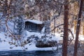 A small and cozy wintery cabin in the middle of Finnish taiga forest Royalty Free Stock Photo