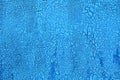 Small cracked grunge blue background of old paint. Parched earth pattern Royalty Free Stock Photo