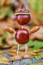 Small creature made of chestnuts and acorns Royalty Free Stock Photo