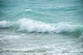 Small cresting wave in the Atlantic Ocean on the coast. Blue green ocean waves with sea foam and salt water spray. Beach travel Royalty Free Stock Photo