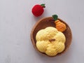 Small crochet basket with fruits and pumpkin. Knitted toys. Top view.