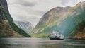 A small cruise ship with tourists begins a trip to the fjord in Norway