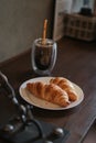 Small cup of coffee and croissants on office desk. Royalty Free Stock Photo
