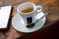 Small cup of espresso coffee on primitive wooden table