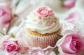 small cupcake surrounded by pink roses and white frosting Royalty Free Stock Photo