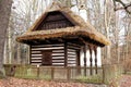 Small curbed cottage with white and brown lines and straw roof Royalty Free Stock Photo