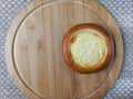Small curd cheesecake on a round wooden board
