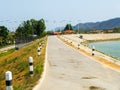 Small Curved Country Road by The Lake to The Mountain