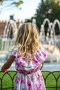 Small girl in beautiful dress admiring fountain in Verona Italy Royalty Free Stock Photo