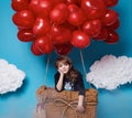 Small cute girl flying on red heart balloons Valentines day Royalty Free Stock Photo