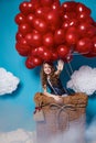 Small cute girl flying on red heart balloons Valentines day Royalty Free Stock Photo