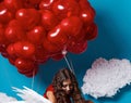 Small cute girl flying on red heart balloons Valentines day Royalty Free Stock Photo