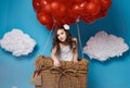 Small cute girl flying on red heart balloons Valentines day Royalty Free Stock Photo