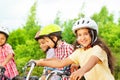 Small cute girl in helmet holds bike handle-bar