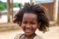 Small cute Malagasy girl with long hair , little dancer on celebration in village Bekopaka, region Melaky, Madagascar.