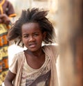 Small cute Malagasy girl with long hair , little dancer on celebration in village Bekopaka, region Melaky, Madagascar