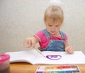 Small cute painting girl at home