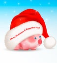 Small cute piggy a chinese new year symbol peeking out from under big Santa Claus hat with greeting Merry Christmas ans Happy New Royalty Free Stock Photo