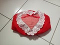 A small cute pretty heart shaped red tissue box on the floor Royalty Free Stock Photo