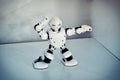 Small cyborg robots, humanoids with face and body dances to music Royalty Free Stock Photo