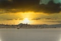 Small dalmatian town of Biograd na Moru, seen from the distance from a nearby hill. Moment of the sun setting in late afternoon,