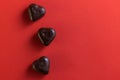 small dark chocolates on red