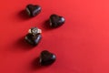 small dark chocolates on red