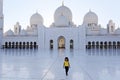 Small dark skin girl walk at Abu Dhabi Grand Mosque