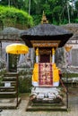 Small decorated altar for celebration with textile and tedung umbrellas in Gunung Kawi, close to Ubud on Bali island, Indonesia