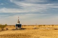 Small decorated hindu temple in the middle of desert with cloudy blue sky Royalty Free Stock Photo