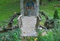 Small decorated stone christian monument in park