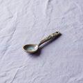 A small, decorative ceramic spoon rests Royalty Free Stock Photo